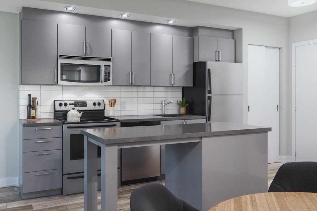 a kitchen with stainless steel appliances and a table