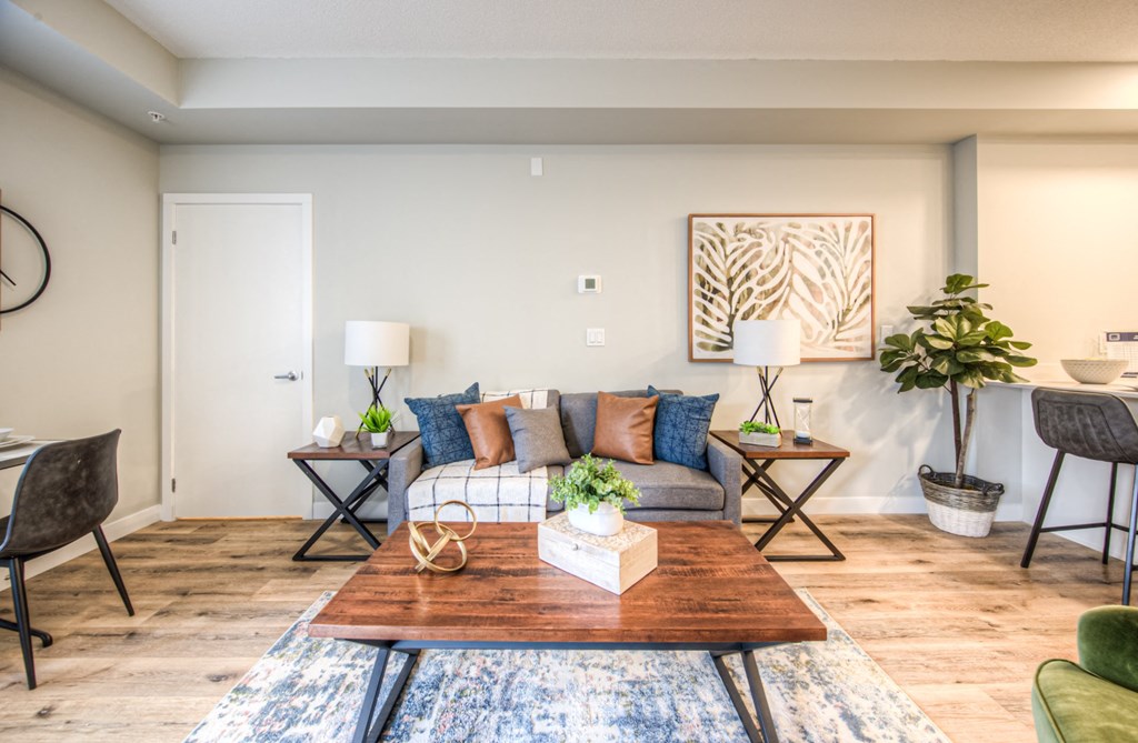 a living area with a couch coffee table and a dining table