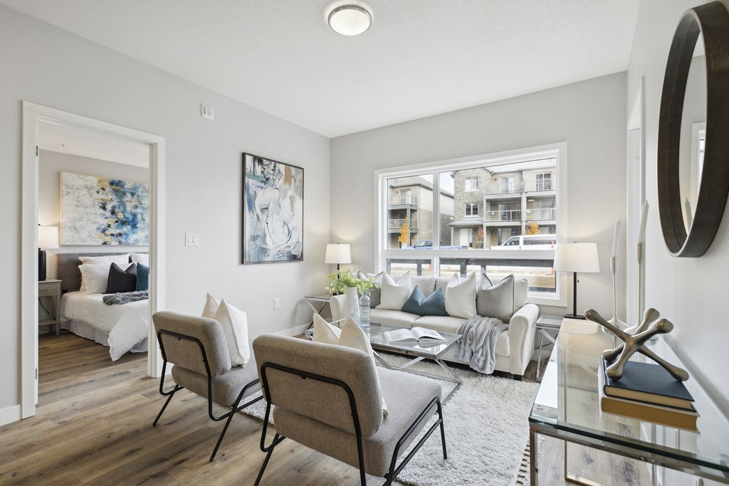 a living room with a couch and chairs and a table