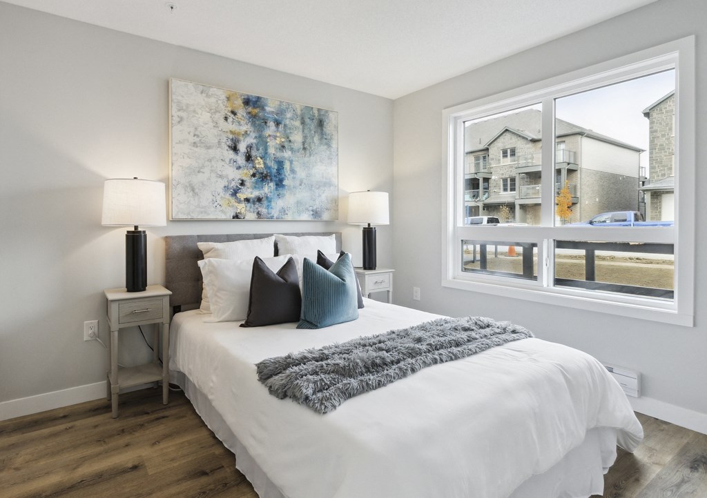 a bedroom with a bed and a large window