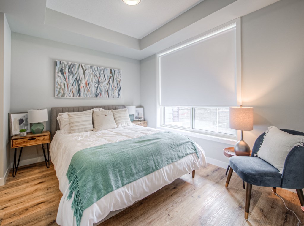 a bedroom with a bed and a chair