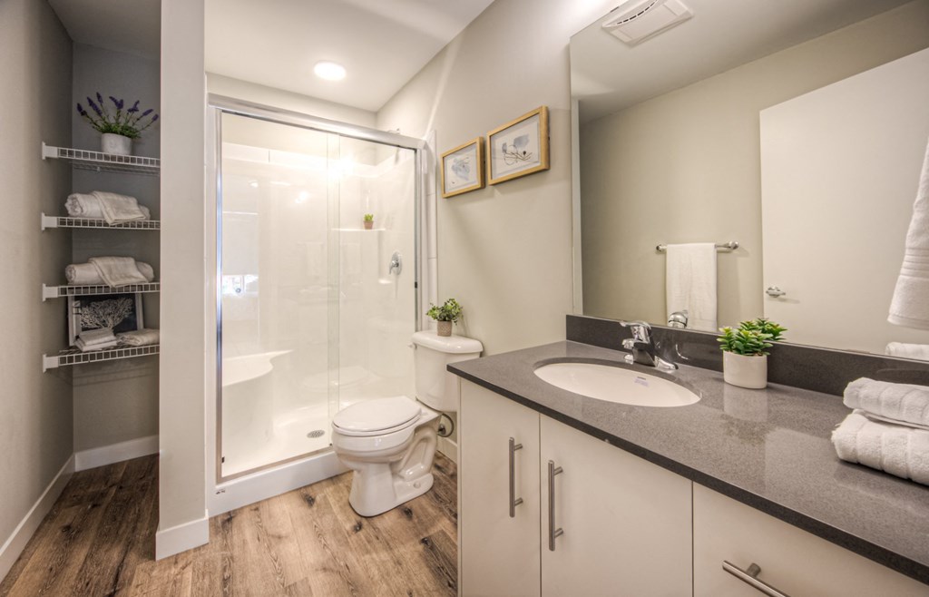 a bathroom with a toilet sink and shower