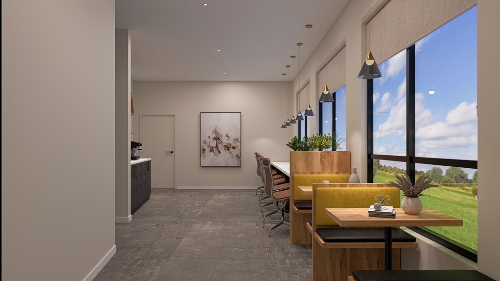 A modern office space with a view of the sky and greenery outside the windows.