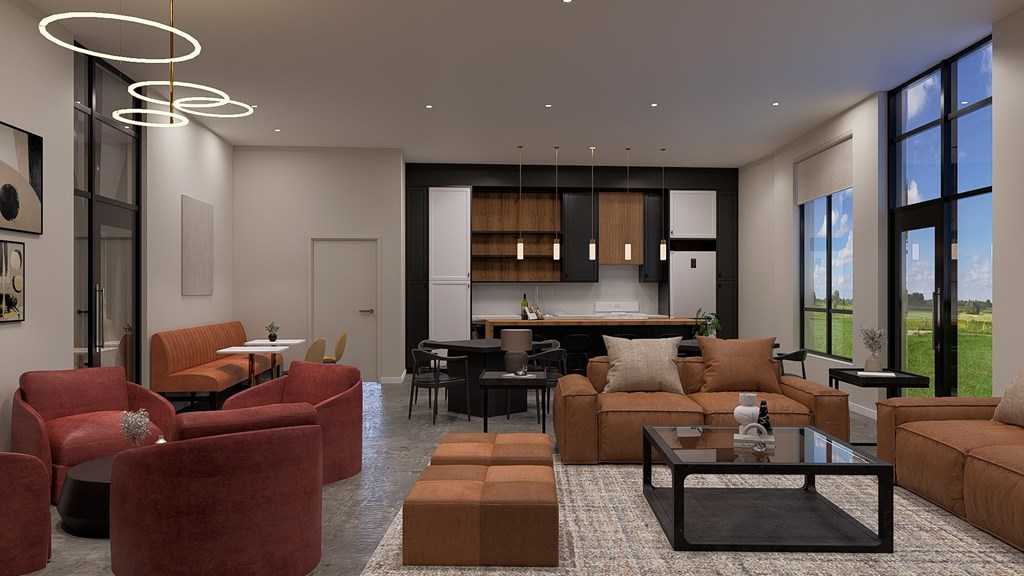 A modern living room with a large window and a kitchen in the background.