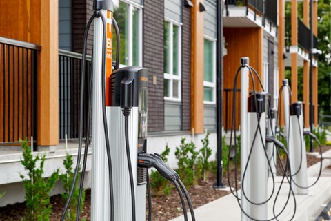 Electric vehicle charging station in front of a building.