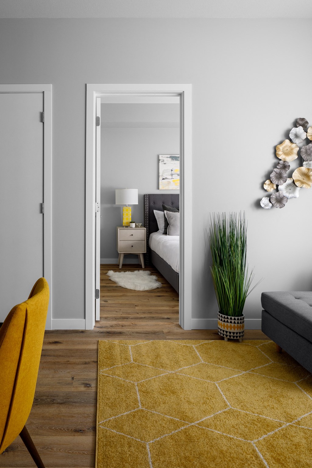 a living room with grey walls and a yellow rug