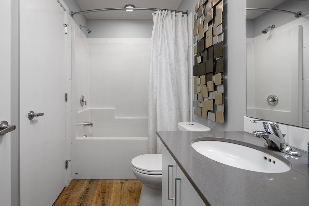 a bathroom with a sink toilet and shower