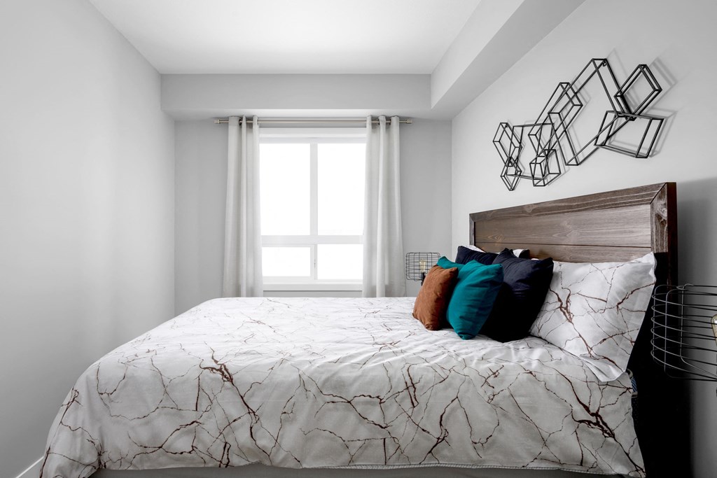 a bedroom with a bed and a window