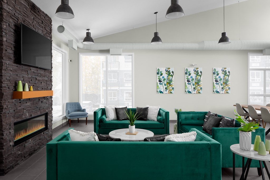 a living room with green couches and chairs
