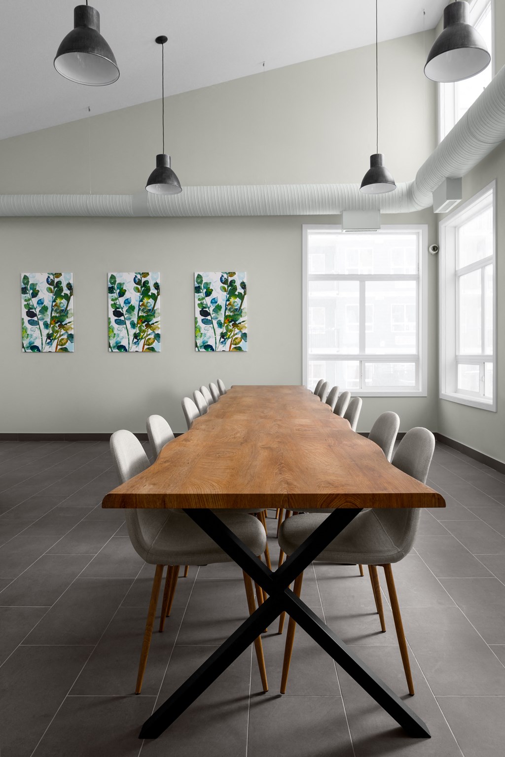 a room with a long wooden table and white chairs