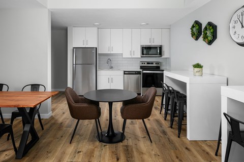 A modern kitchen with a dining table and chairs.
