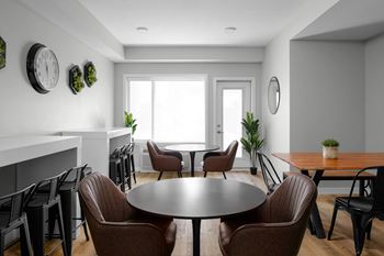 A modern dining room with a round table and chairs.