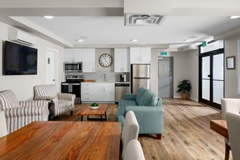 a living room with a couch a table and a chair