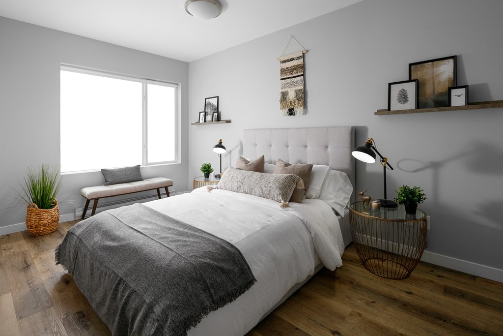A bedroom with a large bed and a window.