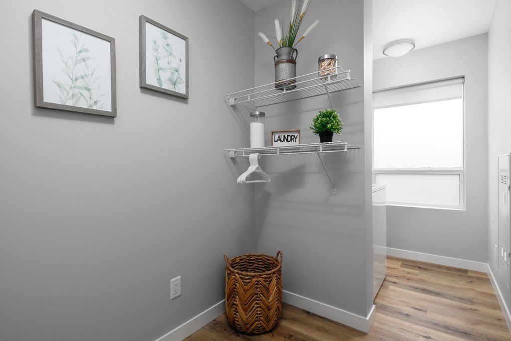 a small bathroom with grey walls and a basket on the floor