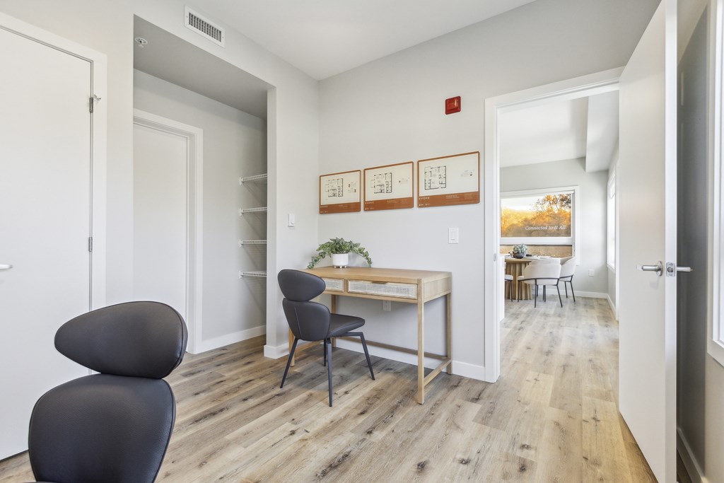 A room with a desk and a chair.
