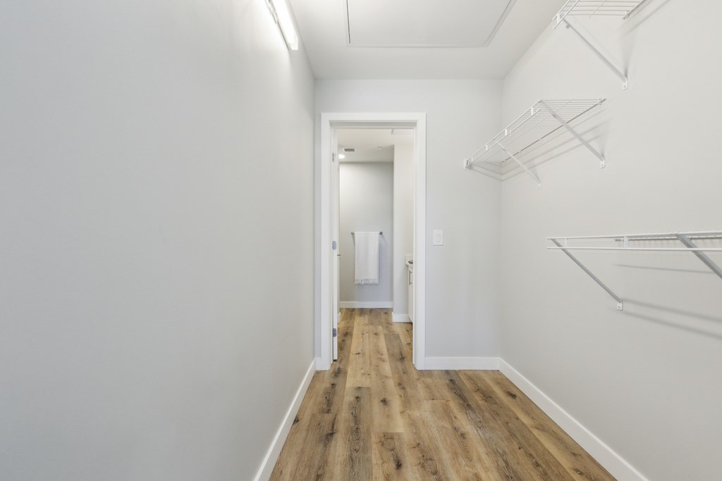 A long hallway with a door at the end.