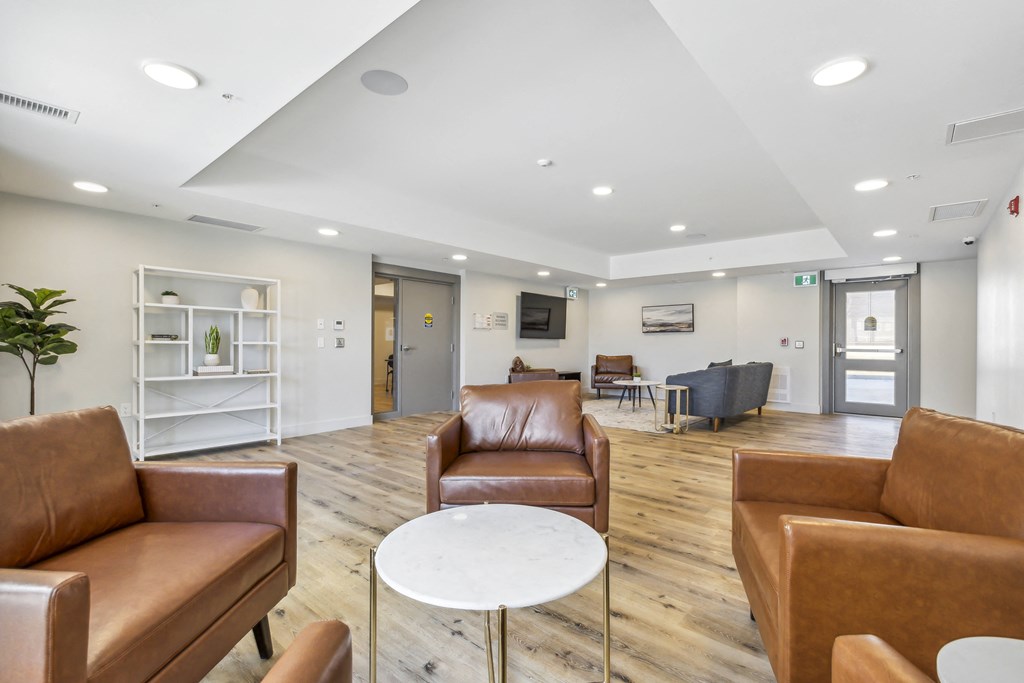 a living room with leather chairs and a table