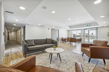 a living room with couches and chairs and a table