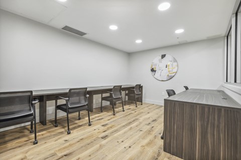 a conference room with a long table and chairs and a desk