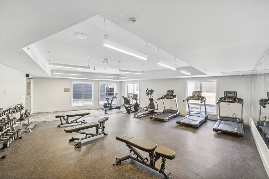 a fitness room with weights and exercise machines
