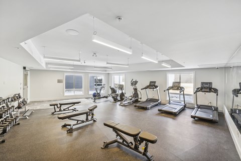 a fitness room with weights and exercise machines