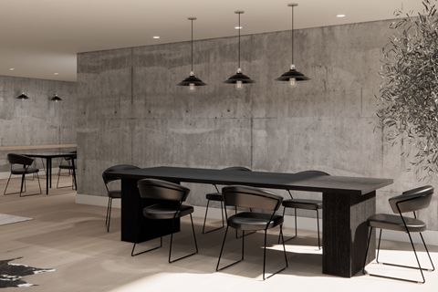 A modern dining room with a concrete wall and black chairs.
