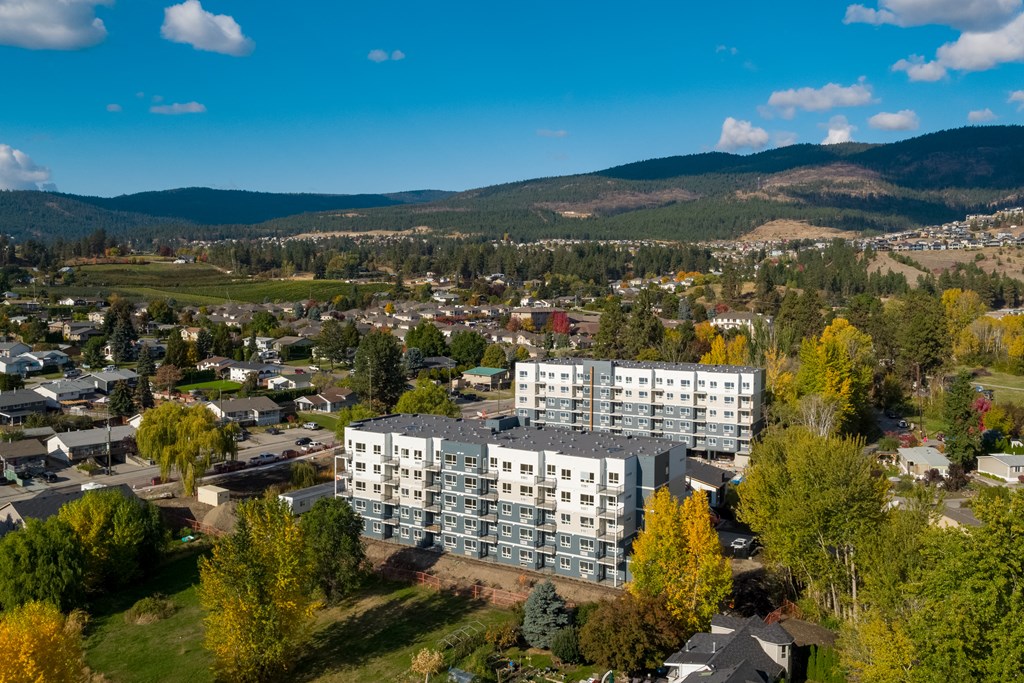 an aerial view of a large apartment complex with a mountain in the background