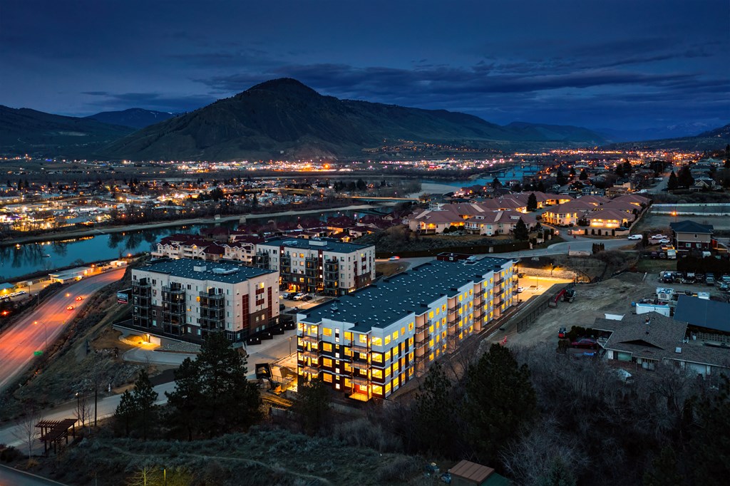 a city at night with a mountain in the background