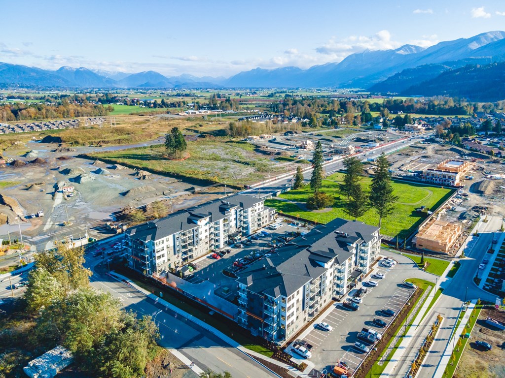a view from above of a large apartment complex with a mountain in the background