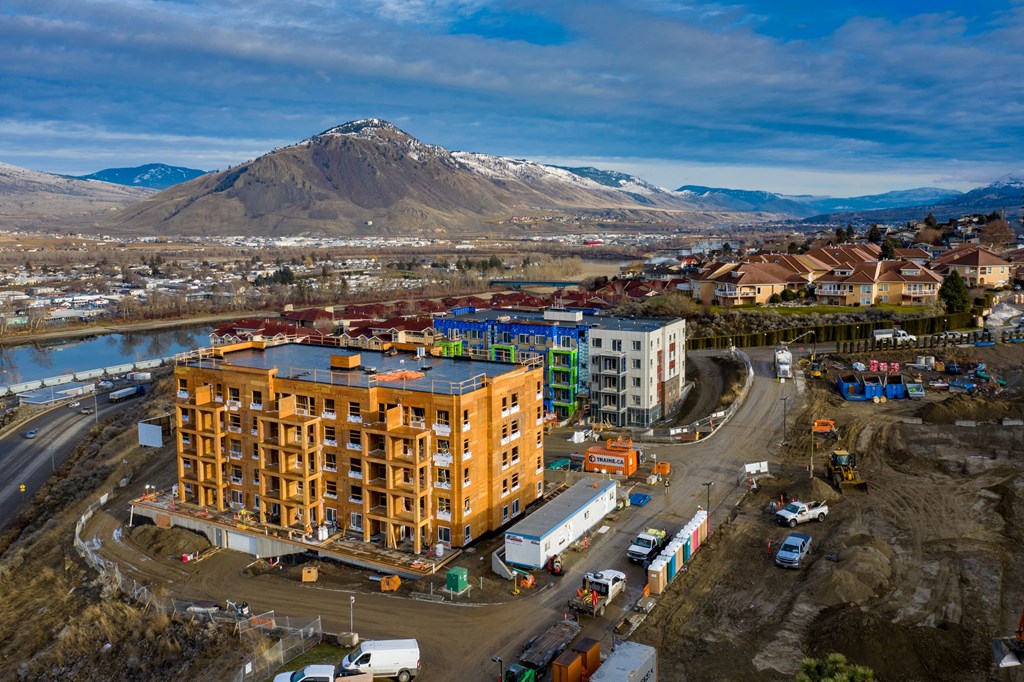a building under construction with a mountain in the background
