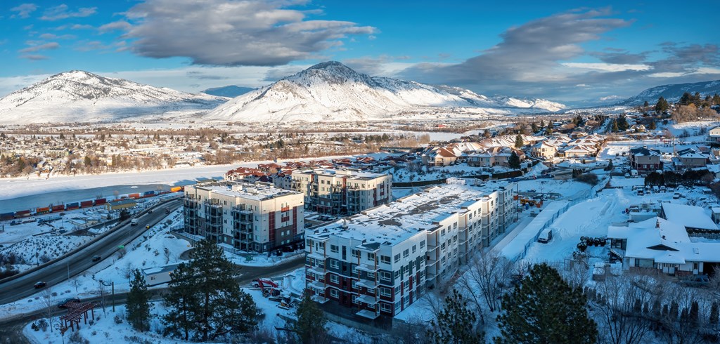 a city covered in snow with a mountain in the background