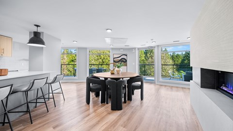 A modern dining room with a wooden table and chairs.