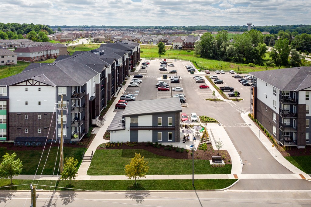a view from the top of a building of a street with cars parked on the side of