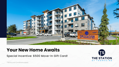 A modern apartment complex with a sign offering a $500 move-in gift card.