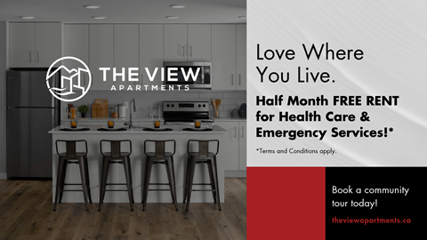 A modern kitchen with a sign offering half month free rent for health care and emergency services.