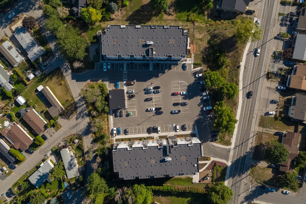 an aerial view of a large building with a parking lot full of cars