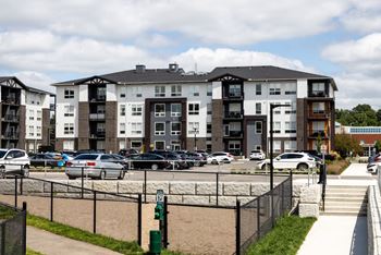 a parking lot in front of an apartment complex