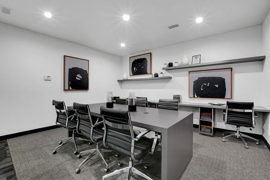 a conference room with a long desk and chairs at Evoq Apartment Homes, Las Vegas Nevada  