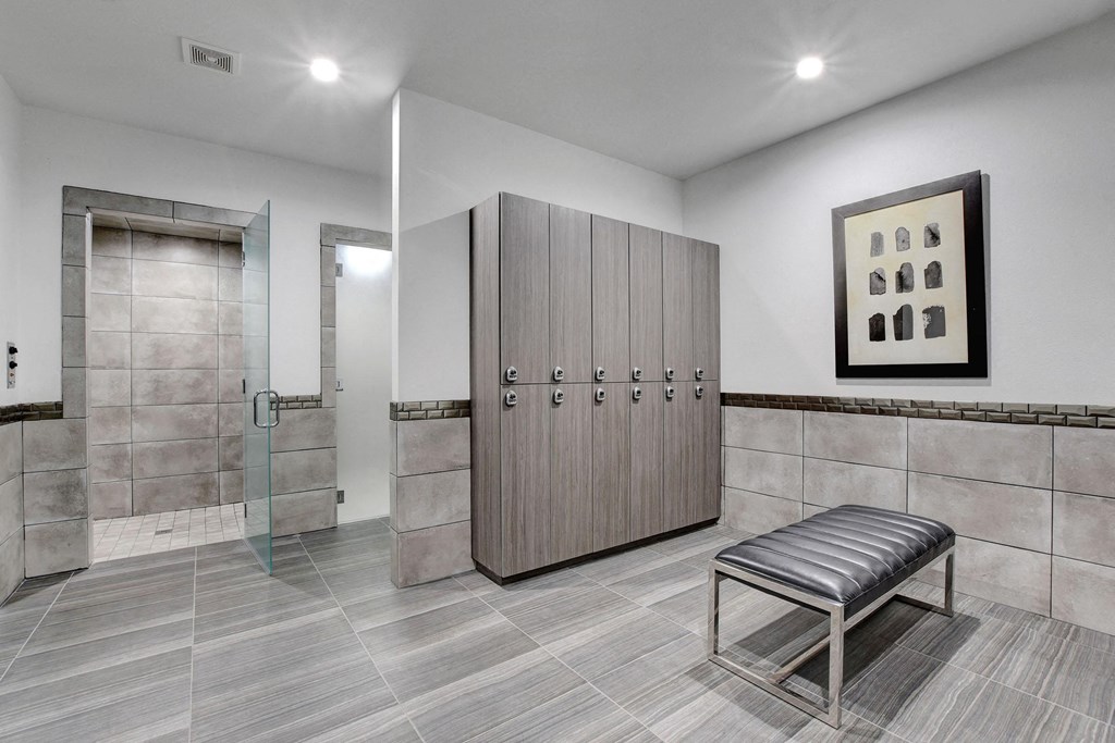 locker room with lockers and a bench at Evoq Apartment Homes, Las Vegas, NV 89169  