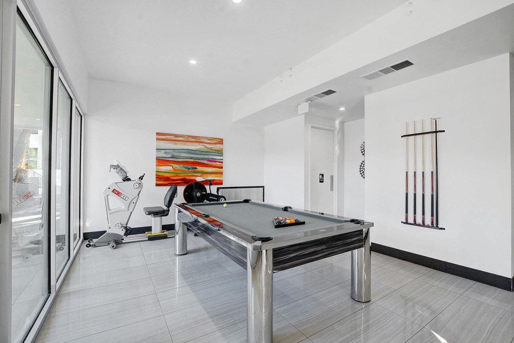 a games room with a ping pong table and a treadmill at Evoq Apartment Homes, Las Vegas, NV 89169  