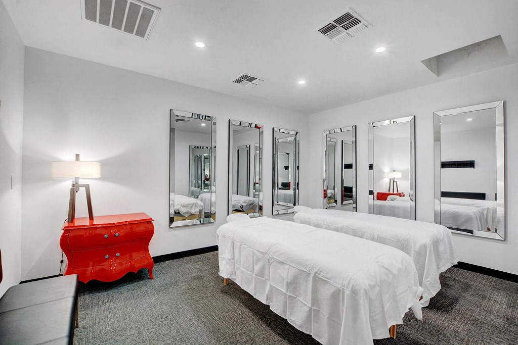 a bedroom with two beds and a red dresser at Evoq Apartment Homes, Las Vegas, 89169  