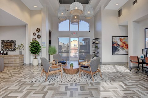 a living room with a table and chairs and a large window