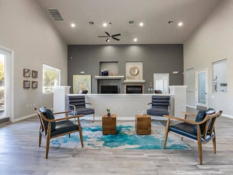 a living room with a couch and chairs and a fireplace