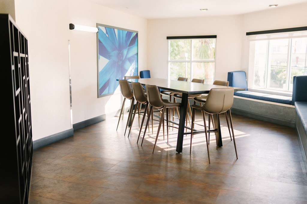 a dining room with a table and chairs and a window