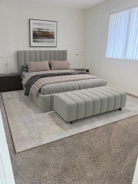 A bedroom with a large bed and a framed picture on the wall at Boulder Creek Apartments, Nevada, 89433