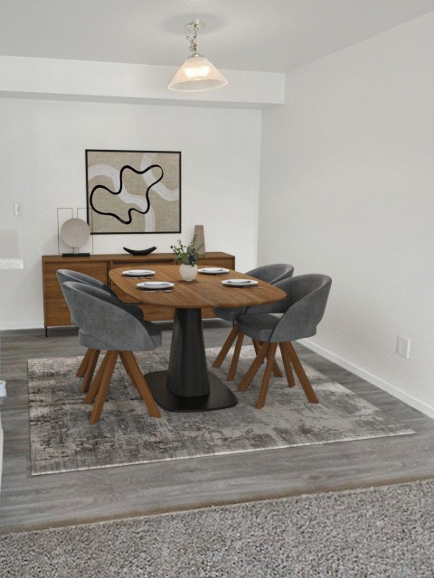 A dining table with grey chairs and a grey rug in a room at Boulder Creek Apartments, Nevada, 89433