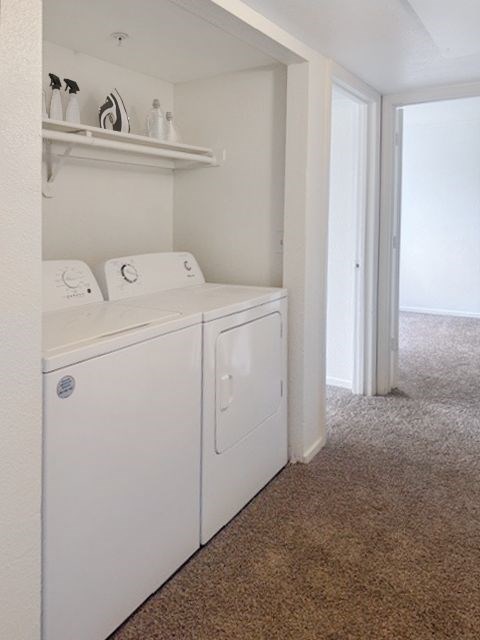 A white washer and dryer in a laundry room at Boulder Creek Apartments, Nevada, 89433