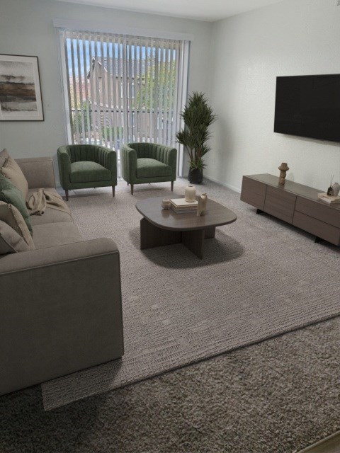 A living room with a grey couch, two green chairs, a coffee table, and a flat screen TV mounted on the wall at Boulder Creek Apartments, Nevada, 89433