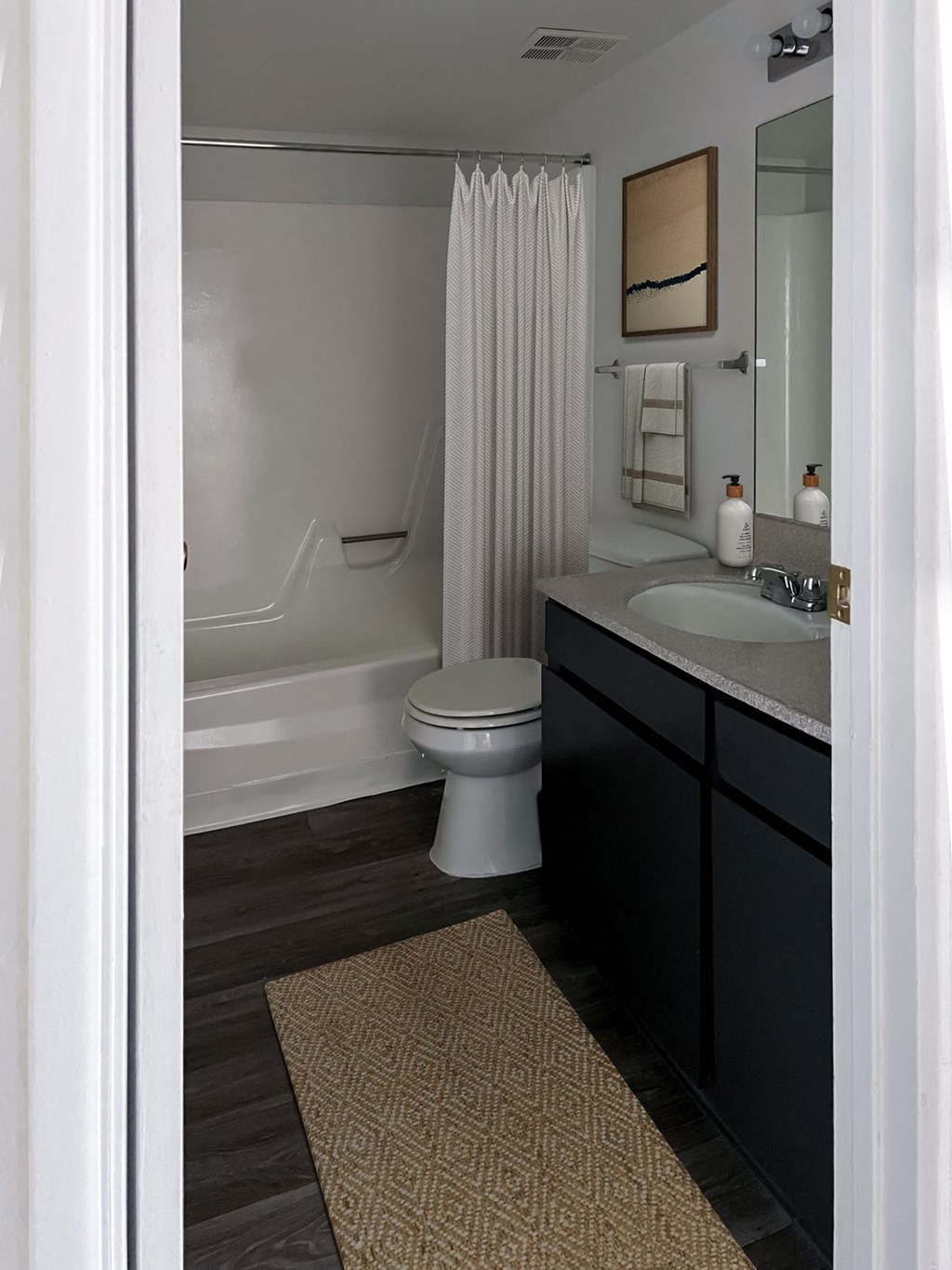 a bathroom with a sink and a toilet and a bath tub at Evoq Apartment Homes, Las Vegas, NV  